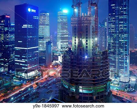 The construction of the Shanghai Tower in Shanghai, China next to the Shanghai World Financial Center and the Jin Mao Tower View Large Photo Image Stock Photo - The construction of the Shanghai Tower in Shanghai, China next to the Shanghai World Financial Center and the Jin Mao Tower. Fotosearch