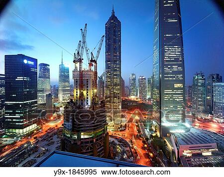 The construction of the Shanghai Tower in Shanghai, China next to the Shanghai World Financial Center and the Jin Mao Tower View Large Photo Image Stock Photography - The construction of the Shanghai Tower in Shanghai, China next to the Shanghai World Financial Center and the Jin Mao Tower. Fotosearch