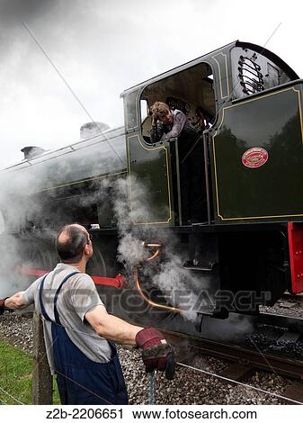 Stock Image - The driver of a vintage classic steam locomotive at Peak Rail Steam preservation, Matlock, Derbyshire, UK.. Fotosearch