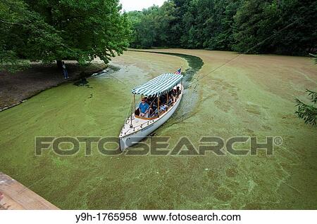 Stock Photo - The electric boat cuts a swath in the lullwater section of the Prospect Park Lake in Brooklyn in New York. Fotosearch