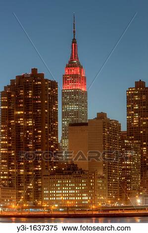 The Empire State Building and other Manhattan buildings at twilight in New York City, USA. The Empire State Building was lighted in red in honor of World Aids Day. View Large Photo Image Stock Photography - The Empire State Building and other Manhattan buildings at twilight in New York City, USA. The Empire State Building was lighted in red in honor of World Aids Day.. Fotosearch