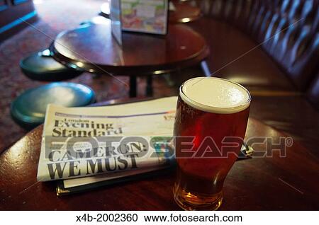 the Evening Standard newspaper and a pint of beer Fitzroy tavern pub London England Britain UK Europe. View Large Photo Image Stock Image - the Evening Standard newspaper and a pint of beer Fitzroy tavern pub London England Britain UK Europe.. Fotosearch