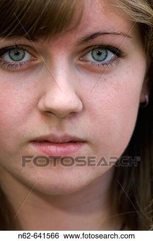 The face of a teen with blue eyes looking towards the camera View Large Photo Image Stock Photograph - The face of a teen with blue eyes looking towards the camera. Fotosearch