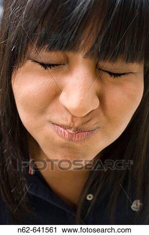 The face of a teenager who makes funny faces bulging cheeks and closed her eyes View Large Photo Image Stock Image - The face of a teenager who makes funny faces bulging cheeks and closed her eyes. Fotosearch