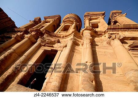 Stock Photo - The famous and elaborately carved fa? ade of Al Deir (the Monastery), carved out of a sandstone rock face, low-angle shot. Jordan (Hashemite Kingdom of), Ma'an Governorate (Maan), ancient city of Petra. Model Released.. Fotosearch