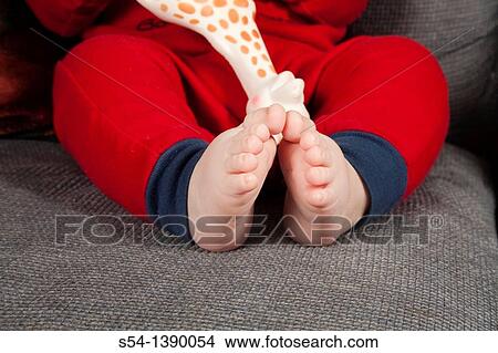 Picture - The feet of a four-month-old baby boy. Fotosearch