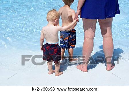 The first time to step into a big pool of water is new, different and a bit scary for a little toddler View Large Photo Image Stock Photo - The first time to step into a big pool of water is new, different and a bit scary for a little toddler. Fotosearch