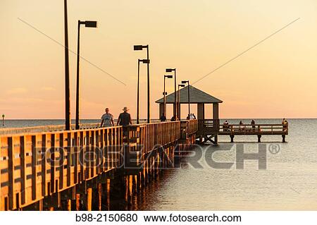 The fishing pier at sunset on the Gulf of Mexico in Biloxi, Mississippi. View Large Photo Image Stock Image - The fishing pier at sunset on the Gulf of Mexico in Biloxi, Mississippi.. Fotosearch