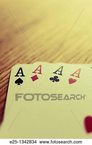 The four ace cards from a pack of cards on a wooden table. No sharpening applied. View Large Photo Image Picture - The four ace cards from a pack of cards on a wooden table. No sharpening applied.. Fotosearch