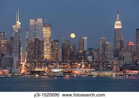 The full moon rises over the Manhattan skyline at twilight as viewed over the Hudson River from New Jersey View Large Photo Image Stock Photography - The full moon rises over the Manhattan skyline at twilight as viewed over the Hudson River from New Jersey. Fotosearch