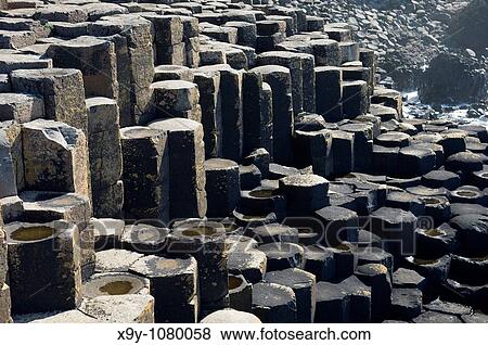 The Giants Causeway near Bushmills, Northern Ireland Volcanic basalt rock hexagonal columns of the Honeycomb formation View Large Photo Image Stock Photo - The Giants Causeway near Bushmills, Northern Ireland Volcanic basalt rock hexagonal columns of the Honeycomb formation. Fotosearch