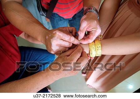 Stock Photo - The gifts of gold wristlets from the bride's parents, Sibu, Sarawak, Malaysia.. Fotosearch