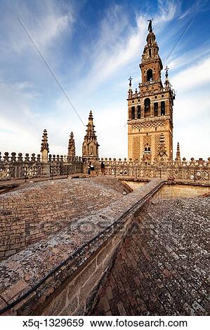Stock Photo - The Giralda Tower as seen from the roof of Santa Maria de la Sede Cathedral, Seville, Spain. Fotosearch