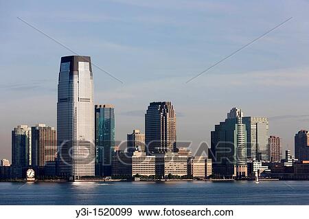 The Goldman Sachs Tower and Colgate-Palmolive clock along with other buildings overlooking the Hudson River in Jersey City, New Jersey, USA View Large Photo Image Stock Photo - The Goldman Sachs Tower and Colgate-Palmolive clock along with other buildings overlooking the Hudson River in Jersey City, New Jersey, USA. Fotosearch