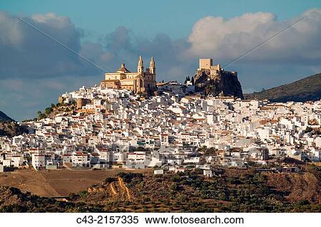 The hilltop White Town of Olvera with its La Encarnaci? n church and Moorish castle is surrounded by olive groves. CBdiz province, Andalusia, Spain. View Large Photo Image Stock Photography - The hilltop White Town of Olvera with its La Encarnaci? n church and Moorish castle is surrounded by olive groves. CBdiz province, Andalusia, Spain.. Fotosearch