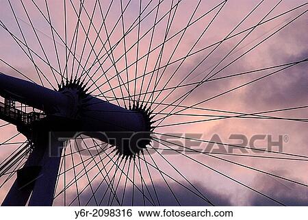The hub of the London Eye seen against a dramatic sunset in the heart of London, England, on a Winter evening. View Large Photo Image Stock Photograph - The hub of the London Eye seen against a dramatic sunset in the heart of London, England, on a Winter evening.. Fotosearch