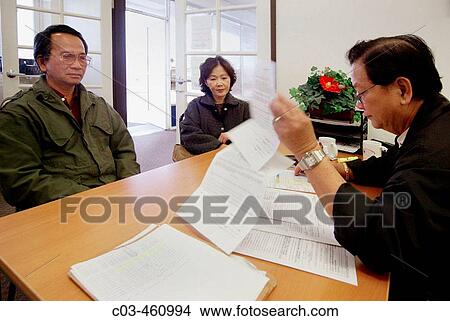 The intake clerk at a neighborhood health clinic in a Vietnamese neighborhood in Fullerton, California records new patients? medical and insurance information View Large Photo Image Picture - The intake clerk at a neighborhood health clinic in a Vietnamese neighborhood in Fullerton, California records new patients? medical and insurance information. Fotosearch