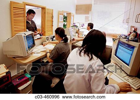 The intake clerk at a neighborhood health clinic in a Vietnamese neighborhood in Fullerton, California records new patients? medical and insurance information View Large Photo Image Stock Photograph - The intake clerk at a neighborhood health clinic in a Vietnamese neighborhood in Fullerton, California records new patients? medical and insurance information. Fotosearch