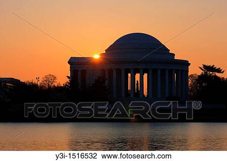 Stock Image - The Jefferson Memorial backlit by the rising sun, Washington, DC, USA. Fotosearch