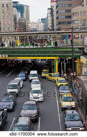 Picture - The JR Chuo line train platform at Iidabashi Station sits above the traffic on Mejiro-dori Avenue, Chiyoda Ward, Tokyo, Japan. Fotosearch