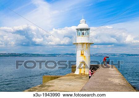 The lighthouse at the end of the breakwater beside Brixham Marina overlooking Torbay, Devon, England. View Large Photo Image Stock Image - The lighthouse at the end of the breakwater beside Brixham Marina overlooking Torbay, Devon, England.. Fotosearch