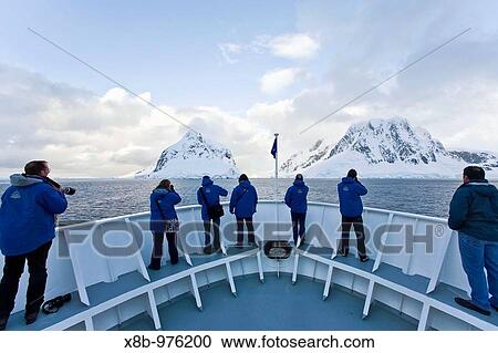 The Lindblad Expedition ship National Geographic Explorer transits Lemaire Channel in late evening light on the west side of the Antarctic peninsula in Antarctica View Large Photo Image Stock Image - The Lindblad Expedition ship National Geographic Explorer transits Lemaire Channel in late evening light on the west side of the Antarctic peninsula in Antarctica. Fotosearch