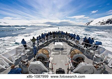 Stock Photo - The Lindblad Expedition Ship National Geographic Explorer pushing through pack and sea ice in Antarctica in the summer months. Fotosearch