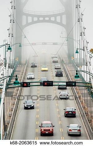 Stock Photography - The Lions Gate Bridge in the fog in Vancouver, BC, Canada.. Fotosearch