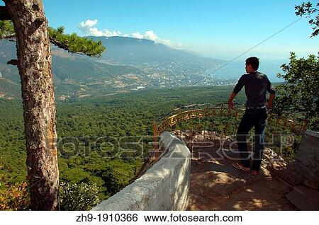 the man looks on Yalta with Ai-Petri Ay Petri peak, Crimean Mountains, Crimea, Ukraine, Eastern Europe View Large Photo Image Stock Photograph - the man looks on Yalta with Ai-Petri Ay Petri peak, Crimean Mountains, Crimea, Ukraine, Eastern Europe. Fotosearch