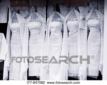 Stock Image - The Mannequins & Traditional Cloths Punjabi dress arranged at window display in a ladies garment shop Pune, Maharashtra, India. Fotosearch