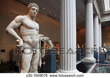 Stock Photograph - The marble statue of a youthful Hercules from Roman Flavian period display in the exhibition hall of Greek and Roman art in Metropolitan Museum of Art Manhattan New York City USA.. Fotosearch