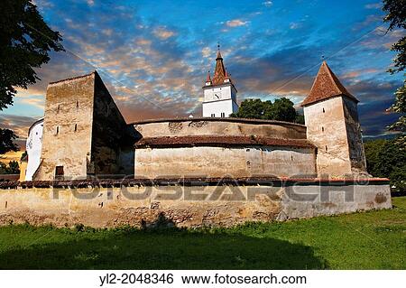 The medieval fortified church of Harman. A Romaneque church started in 1240 by the Cistercian monks with Gothic elements of architecture. Harman, Brasov, Transylvania. UNESCO World Heritage Site. View Large Photo Image Stock Photograph - The medieval fortified church of Harman. A Romaneque church started in 1240 by the Cistercian monks with Gothic elements of architecture. Harman, Brasov, Transylvania. UNESCO World Heritage Site.. Fotosearch