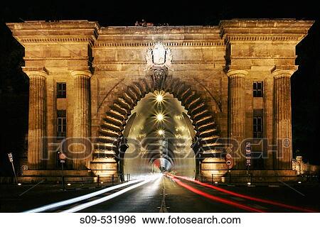 The monumental entrance to the road tunnel that runs through Castle Hill on Clark Adam Ter by night, Budapest, Hungary. View Large Photo Image Stock Photograph - The monumental entrance to the road tunnel that runs through Castle Hill on Clark Adam Ter by night, Budapest, Hungary.. Fotosearch