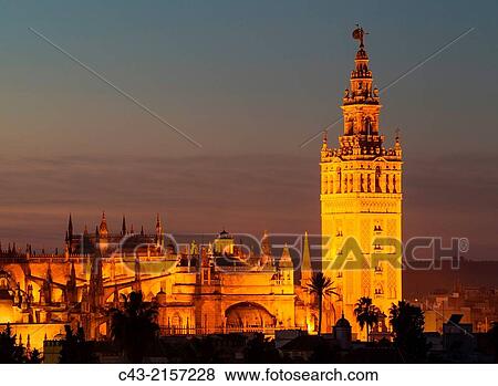 The Moorish Giralda (1184-96) next to the Gothic Cathedral (1402-1506). Illuminated at dusk. Seville, Seville province, Andalusia, Spain. View Large Photo Image Stock Photo - The Moorish Giralda (1184-96) next to the Gothic Cathedral (1402-1506). Illuminated at dusk. Seville, Seville province, Andalusia, Spain.. Fotosearch