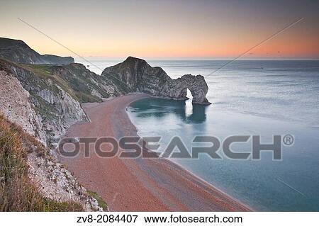 The morning light across Durdle Door on the Jurassic Coastline in Dorset. View Large Photo Image Stock Photo - The morning light across Durdle Door on the Jurassic Coastline in Dorset.. Fotosearch