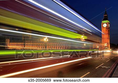 The night view of Big Ben with track of taillights in foreground. London. England. United Kingdom. View Large Photo Image Stock Photo - The night view of Big Ben with track of taillights in foreground. London. England. United Kingdom.. Fotosearch