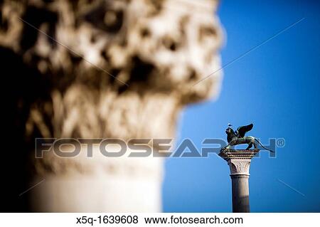 The Piazzetta winged lion background and a column from the Doge's Palace foreground, Venice, Italy View Large Photo Image Stock Photo - The Piazzetta winged lion background and a column from the Doge's Palace foreground, Venice, Italy. Fotosearch