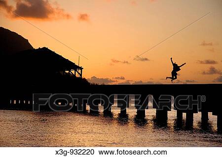 Stock Image - The picturesque beaches on Hanalei Beach during a vibrant sunset, Kauai, Hawaii, USA. Fotosearch