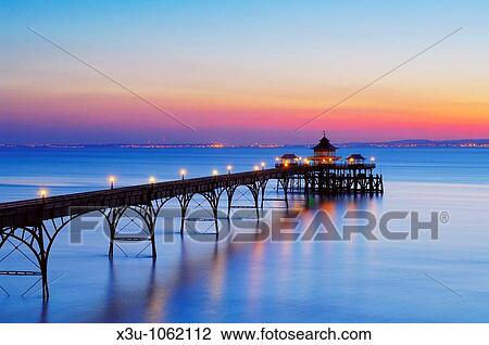 The pier in the Bristol Channel at the seaside town of Clevedon at dusk Somerset, England View Large Photo Image Stock Image - The pier in the Bristol Channel at the seaside town of Clevedon at dusk Somerset, England. Fotosearch