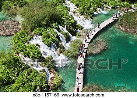 The Plitvice Lakes in the National Park Plitvicka Jezera in Croatia Visitors on the plank paths of the national Park The Plitvice Lakes are a string of lakes connected by waterfalls View Large Photo Image Stock Photo - The Plitvice Lakes in the National Park Plitvicka Jezera in Croatia Visitors on the plank paths of the national Park The Plitvice Lakes are a string of lakes connected by waterfalls. Fotosearch