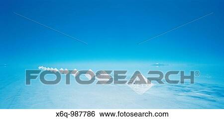 Stock Photograph - The pyramids of salt on the salt flats of the Salar de Uyuni, Bolivia, South America. Fotosearch