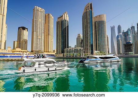 The RTA Dubai Ferry and a private boat in Dubai Marina, Dubai, United Arab Emirates. View Large Photo Image Stock Photograph - The RTA Dubai Ferry and a private boat in Dubai Marina, Dubai, United Arab Emirates.. Fotosearch