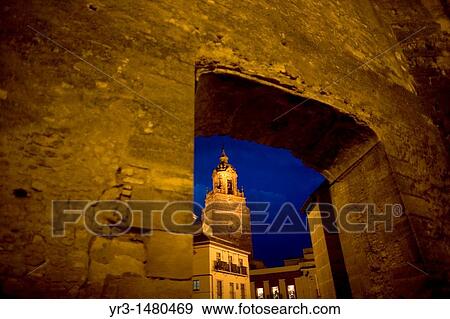 Stock Photo - The San Bartolome church is seen through a door of the Alcazar fortress in Carmona, Seville province, Andalusia, Spain, April 20, 2011. Fotosearch