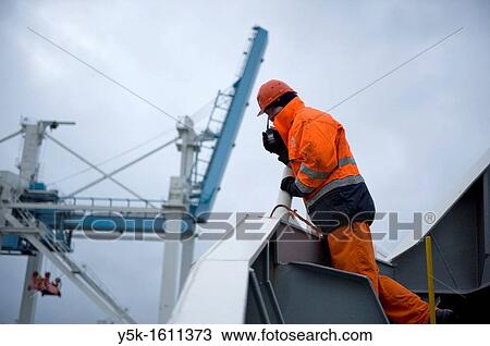 The second officer of container-vessel MV Flintercape is coordinating the docking of the ship in Stockholm harbor for loading and unloading containers. View Large Photo Image Stock Image - The second officer of container-vessel MV Flintercape is coordinating the docking of the ship in Stockholm harbor for loading and unloading containers.. Fotosearch