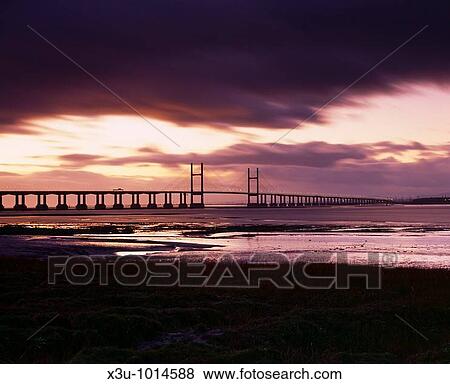 Stock Photo - The Second Severn Crossing over the River Severn between England and Wales seen from Redwick in Gloucestershire, United Kingdom. Fotosearch