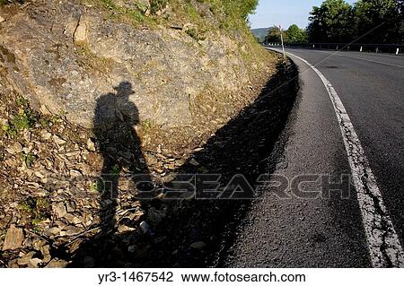 The shadow of a pilgrim is cast as he wlaks in a road in the French Way that leads to Santiago de Compostela, Way of Saint James, Castilla Leon, Spain View Large Photo Image Stock Image - The shadow of a pilgrim is cast as he wlaks in a road in the French Way that leads to Santiago de Compostela, Way of Saint James, Castilla Leon, Spain. Fotosearch