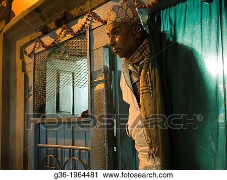 Stock Image - The shape of a man is visible through a curtain of a restaurant in Patan, Nepal.. Fotosearch