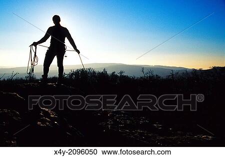 The silhouette of a climber packing his rope, Male Karpaty, Slovakia. View Large Photo Image Stock Image - The silhouette of a climber packing his rope, Male Karpaty, Slovakia.. Fotosearch