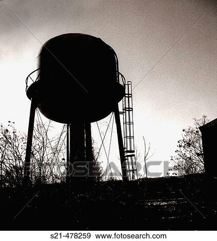 The sillouette of a water tower is captured in black and white against a dramatic sky. View Large Photo Image Stock Photo - The sillouette of a water tower is captured in black and white against a dramatic sky.. Fotosearch