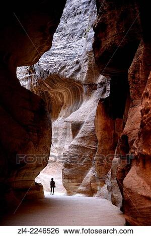 Stock Photograph - The Siq, a narrow gorge of 1. 2km long and up to 200m deep, the main entrance to Petra. Jordan (Hashemite Kingdom of), Ma'an Governorate (Maan), ancient city of Petra. Model Released.. Fotosearch